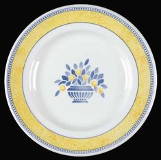 a white and blue plate with yellow trimmings on the rim, decorated with flowers