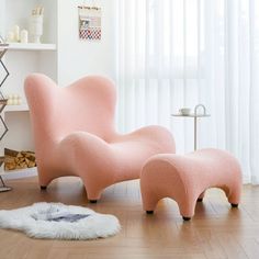 a pink chair and ottoman in a room