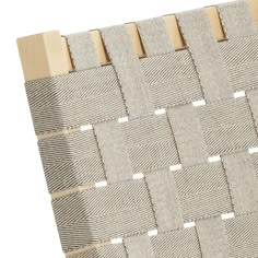 the back side of a chair with woven fabric and wood slats on it, against a white background