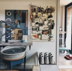 a room filled with lots of different types of items on the wall next to a sink