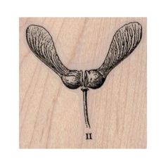 a wooden stamp with an image of a bird on it's wings and the number one