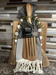 a wooden utensil holder with some white and black items on top of it