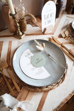 a table setting with place settings, forks and napkins on the plate that has been placed on it