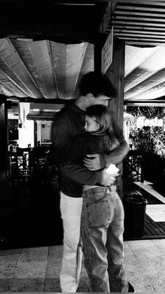 black and white photograph of a man hugging a woman