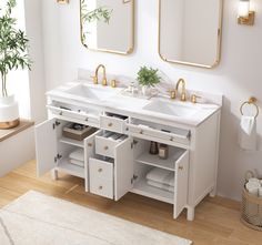 a bathroom vanity with two sinks and gold mirrors on the wall next to a rug