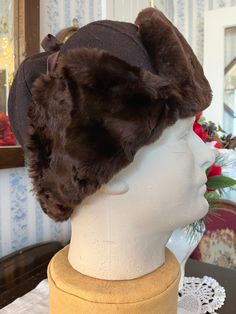 This cap is made of wool felt in dark brown and trimmed with glossy and warm mouton fur in rich brown. It is fully lined with black quilted fabric lining. Marked men's size medium (the mannequin's head measures 21 inches around). In very good condition. Brown Military Hat For Winter, Luxury Brown Fur Felt Hat, Adjustable Vintage Fur Felt Hat, Vintage Adjustable Fur Felt Hat, Vintage Brown Fur Felt Hat, Trapper Hats, Mannequin Heads, Black Quilt, Vintage Brown