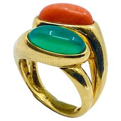 A colorful Boucheron ring made of 18k gold, features chrysoprase and coral. The gem and the coral are both cabochon cut, set one above another. The double shank design provides to this "layering” a great look. Two bright, contrasting colors make each other pop. The polished gold adds to the ring’s curves extra eloquence. This Boucheron ring is a classic example of a unique vintage jewelry piece. DESIGNER: Boucheron CIRCA: 1970’s MATERIALS: 18k Gold GEMSTONE: Coral, Chrysoprase WEIGHT: 10 grams RING SIZE: 6 HALLMARKS: Boucheron 70s Rings, 70s Jewelry, 1970s Jewelry, Vintage Cocktail Ring, Jewels Rings, Cocktail Rings, Vintage Charms, Jewelry Pieces, Gold Jewelry