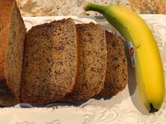 slices of banana bread on a plate next to a loaf of bread and a ripe banana