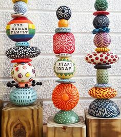 several colorful vases are stacked on top of each other