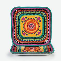 a colorful plate with an intricate design on the front and sides, set against a white background