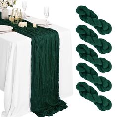 the table is set with green linens and place settings