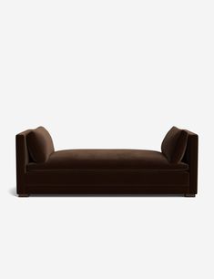 a brown couch sitting on top of a white floor