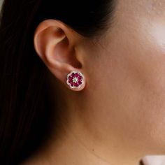 Captivate onlookers with the stunning Buttercup Ruby Studs by Ruchi New York. These earrings feature two pear-shaped rubies, surrounded by a cluster of brilliant cut diamonds. The rubies are the centerpiece of the design, with a combined weight of 2.20 carats that will turn heads with their rich and alluring red hue. The diamonds, with a total weight of .58 carats, beautifully complement the rubies with their exquisite sparkle, making these earrings an exceptional piece for any special occasion. Ruby Stud Earrings, Ruby Earrings Studs, White Gold Set, Flower Earrings Studs, Flower Studs, Diamond Earrings Studs, Brilliant Cut Diamond, Pear Shaped, Pear