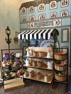 there is a display case in the store with flowers and baskets on it's shelves