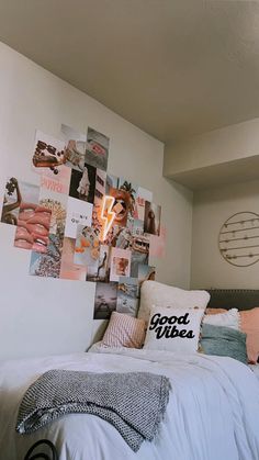 a bed with pillows and pictures on the wall