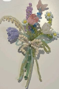 a bunch of beads and flowers on a white surface