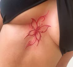 a woman's stomach with a flower tattoo on it