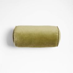 a rolled up pillow sitting on top of a white wall