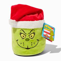 the grin face has been put in a green bag with a santa hat on it