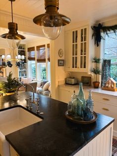 a kitchen with an island and sink in the middle of it, surrounded by windows