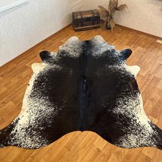 a black and white cowhide rug on the floor