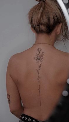 a woman with a flower tattoo on her back