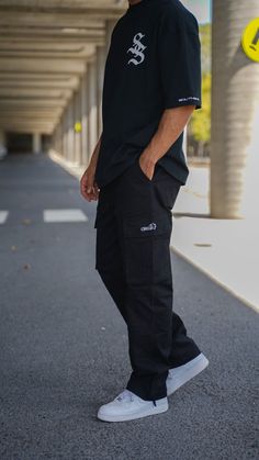 Cargo pants are a streetwear staple and the SS Cargo Pants will elevate your street style. Featuring all the pockets you could possibly need and made with a premium cotton twill, these pants will see you through both the good and the bad. Cop a pair today and lift your game. Colour: Black Male model (6 ft) is wearing size L and female (5'5) is wearing size S Elastic waist with drawstring Pocket Embroidered Logos 100 % cotton Cargo Pants Outfit Street Style For Men, Men Style Inspo Streetwear, Six Pocket Pants Men, Cargo Pant For Men, Men Cargo Pants Outfit Fashion, Male Cargo Pants Outfit, Street Outfits Men, Mens All Black Streetwear, Style Homme Streetwear