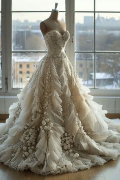 a wedding dress on display in front of a window