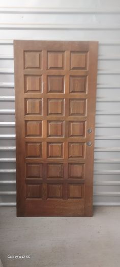 a wooden door sitting inside of a garage