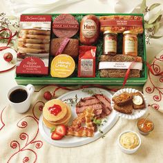 an assortment of food and condiments in a green tray on a white tablecloth