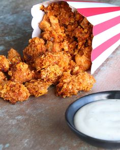 fried food sitting on top of a table next to a bowl of ranch dips