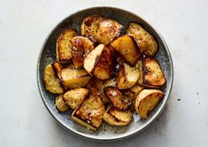 a bowl filled with cooked potatoes on top of a table