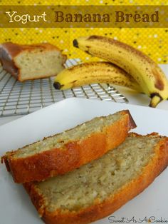 two slices of banana bread sitting on top of a white plate next to some bananas