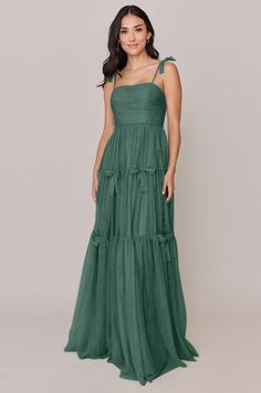 a woman in a long green dress