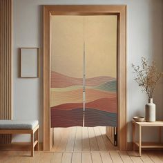 an open door in a room with wood flooring and artwork on the wall behind it