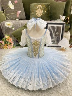 a blue and white dress sitting on top of a floor