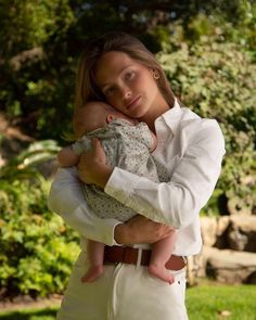 a woman holding a baby in her arms