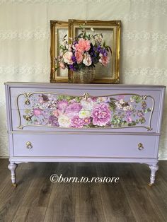 a purple dresser with flowers painted on it