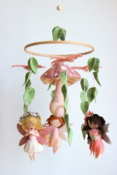 a mobile with dolls hanging from it's sides