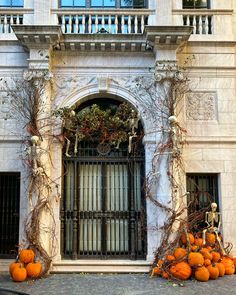 an old building with vines and pumpkins in front