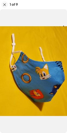 Handmade Kids Sonic The Hedgehog Adjustable Face Mask. Washable reusable. 100% Cotton. Comfortable, adjustable earloops. Double layered, inside is navy blue. Both sides can be worn.  Kids size measures 6.75" across and 4.5" wide. Handmade Kids, Costume Mask, Costume Accessories, Sonic, Sonic The Hedgehog, Face Mask, Mask, Etsy Uk, Blue