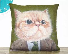 a cat wearing a suit and tie on a pillow with a clock in the background