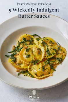 a white plate topped with ravioli and spinach