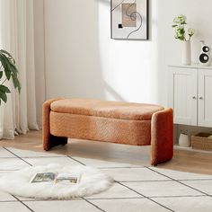 an orange bench sitting on top of a white rug