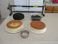 three cakes sitting on top of a kitchen counter