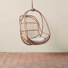 On a neutral background is a natural rattan egg shaped hanging chair with an ivory cushion and rope details. Rattan Hanging Chair, Outdoor Hanging Chair, Hanging Rattan Chair, Rattan Planters, Hanging Rattan, Hanging Chair Outdoor, Rattan Chairs, Rattan Outdoor, Rattan Mirror