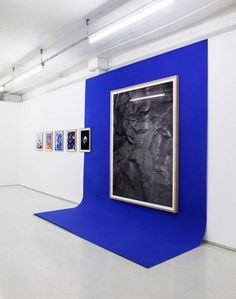 an art gallery with blue and white walls