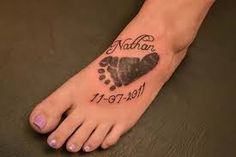 a foot with a heart and paw prints on it that says, nathan 11 - 19 - 2011