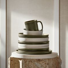 stack of white and green dishes stacked on top of each other