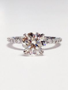 an engagement ring with a round cut diamond in the center